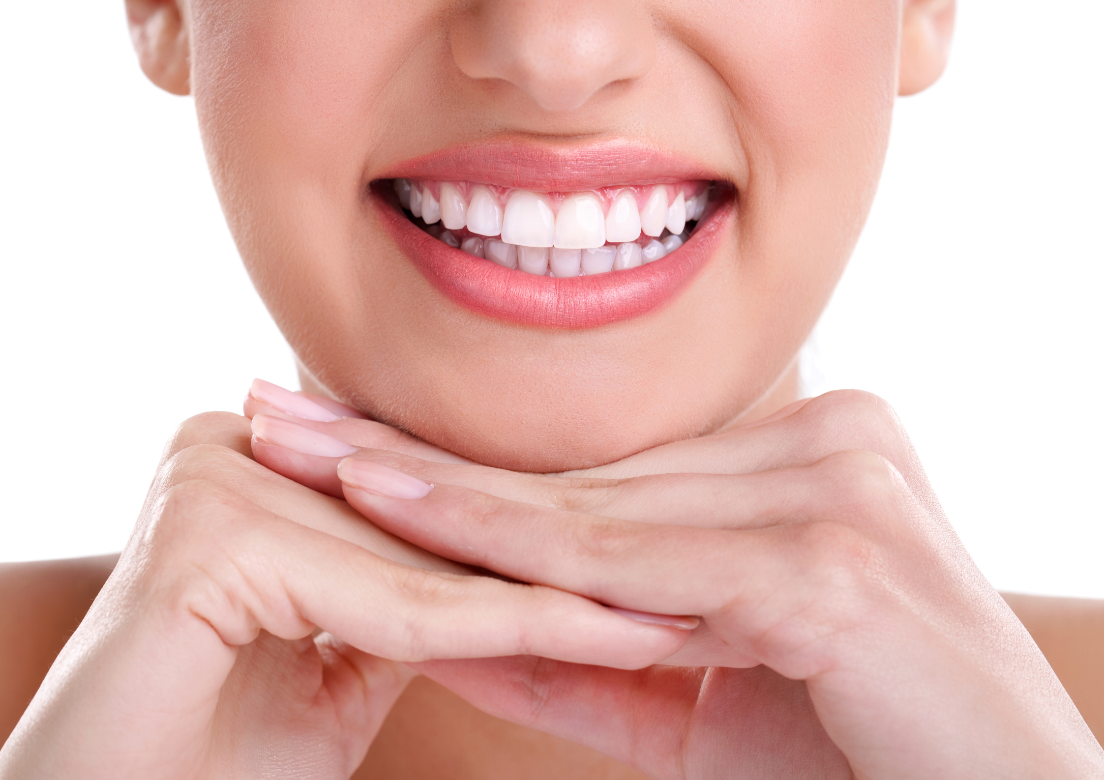 A close-up of a person smiling with bright white teeth, soft pink lips, and resting their chin on their hands, conveying happiness and confidence. A close-up of a person smiling with bright white teeth, soft pink lips, and resting their chin on their hands, conveying happiness and confidence.