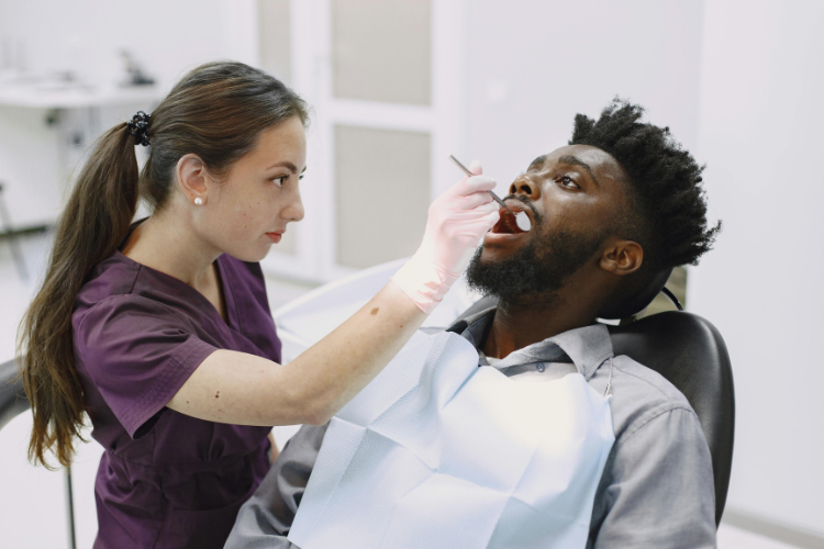 Nervous adult and supportive dentist talking during a check-up
